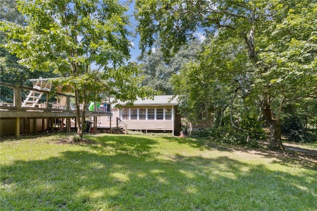 136 Pine St, Covington, GA 30014 - back of property featuring stairs, a deck, a lawn, and a metal roof