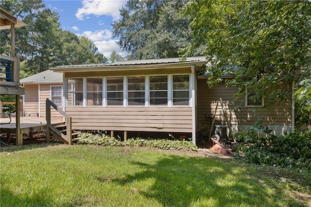 136 Pine St, Covington, GA 30014 - view of front facade with a front lawn, a metal roof, and a deck