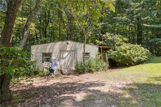 136 Pine St, Covington, GA 30014 - view of outbuilding with a forest view