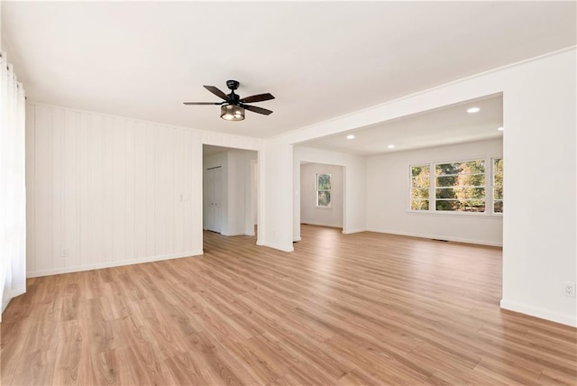 empty room featuring ceiling fan and light hardwood / wood-style floors