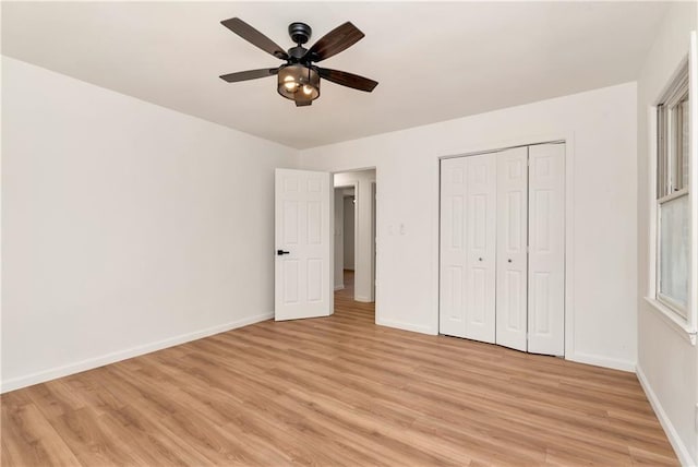 unfurnished bedroom with ceiling fan, light hardwood / wood-style flooring, and a closet