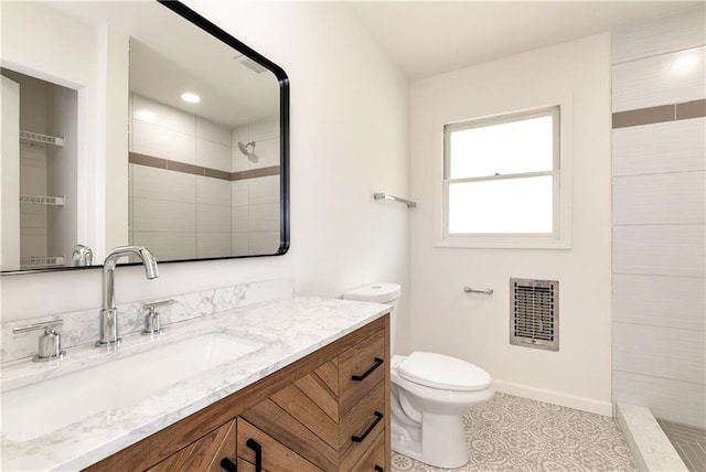 bathroom featuring tile patterned floors, vanity, heating unit, tiled shower, and toilet