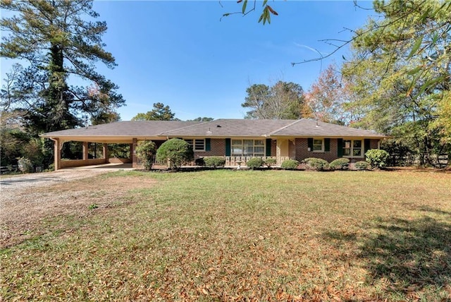 ranch-style home featuring a carport and a front lawn