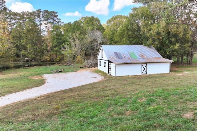 view of outdoor structure featuring a lawn