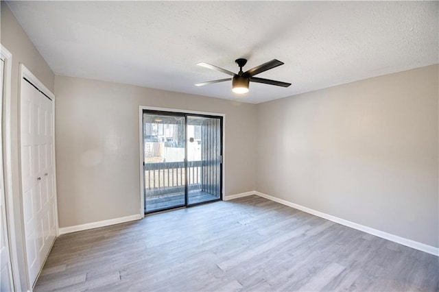 empty room featuring hardwood / wood-style flooring, a textured ceiling, and ceiling fan