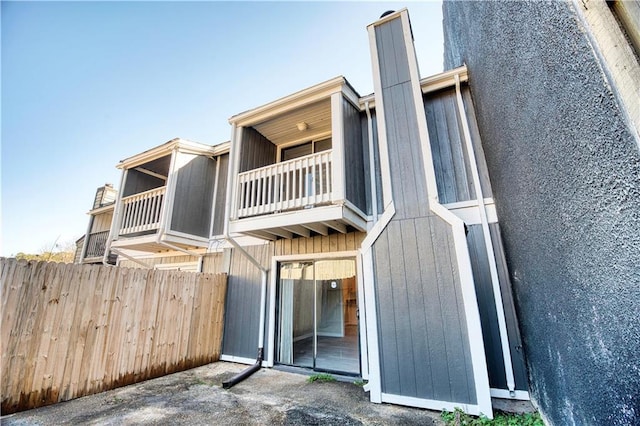 rear view of property with a balcony