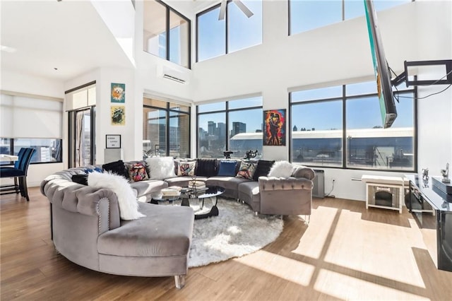 living room with hardwood / wood-style flooring and a wall mounted AC