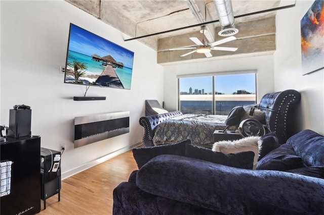bedroom with ceiling fan and hardwood / wood-style flooring