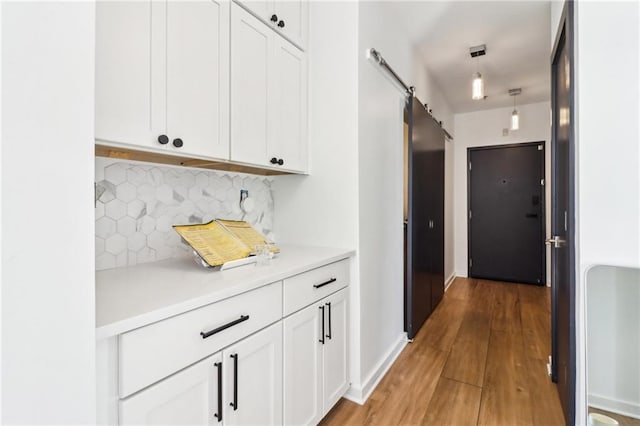 hall featuring a barn door and hardwood / wood-style floors