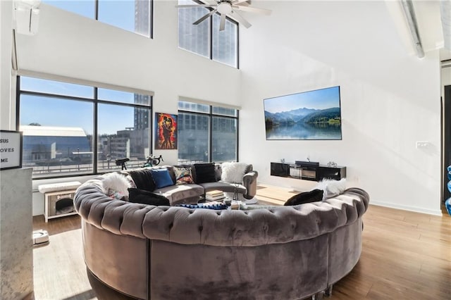 living room featuring light hardwood / wood-style floors and ceiling fan