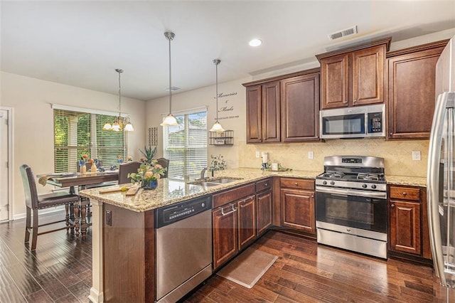 2149 Apple Orchard Way, Austell, GA 30168 - kitchen featuring appliances with stainless steel finishes, dark wood-style flooring, a peninsula, a chandelier, and recessed lighting