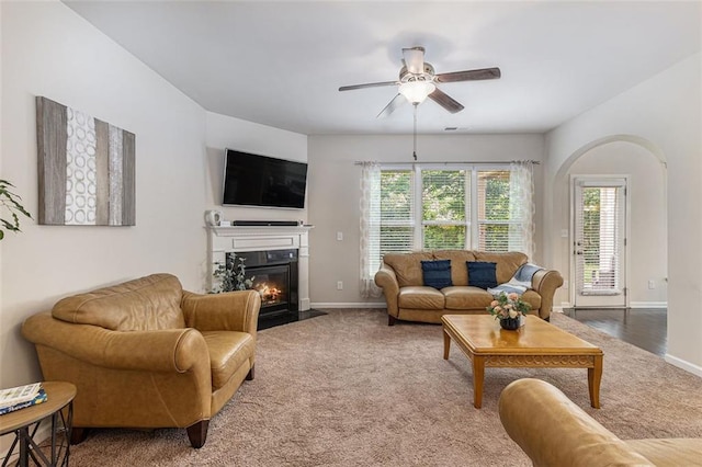 2149 Apple Orchard Way, Austell, GA 30168 - living area with carpet flooring, baseboards, ceiling fan, and a fireplace with flush hearth