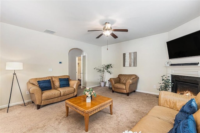 2149 Apple Orchard Way, Austell, GA 30168 - living area with arched walkways, ceiling fan, light carpet, and baseboards