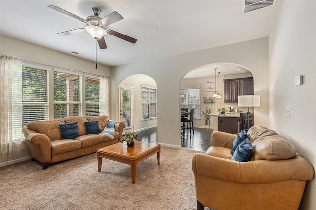 2149 Apple Orchard Way, Austell, GA 30168 - living area featuring arched walkways, ceiling fan, baseboards, and carpet flooring