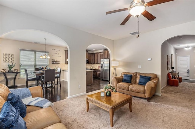 2149 Apple Orchard Way, Austell, GA 30168 - carpeted living room with arched walkways, ceiling fan, baseboards, and a chandelier