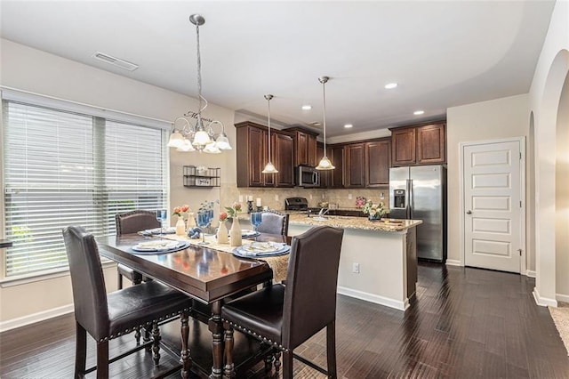 2149 Apple Orchard Way, Austell, GA 30168 - dining room with arched walkways, baseboards, a chandelier, dark wood-style floors, and recessed lighting