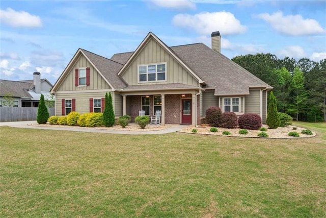 35 Huntington Way, Williamson, GA 30292 - craftsman-style home with a porch, a front lawn, board and batten siding, a chimney, and fence