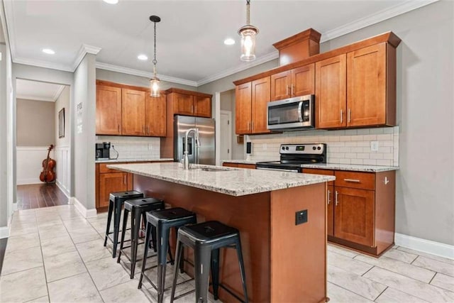 35 Huntington Way, Williamson, GA 30292 - kitchen featuring recessed lighting, a kitchen island with sink, brown cabinetry, stainless steel appliances, and a sink