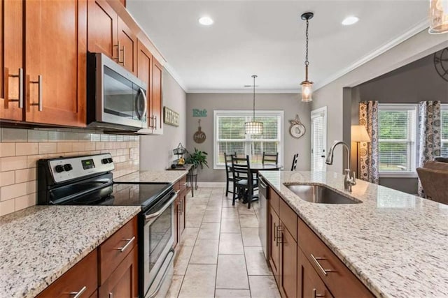 35 Huntington Way, Williamson, GA 30292 - kitchen with a sink, brown cabinets, stainless steel appliances, decorative backsplash, and baseboards