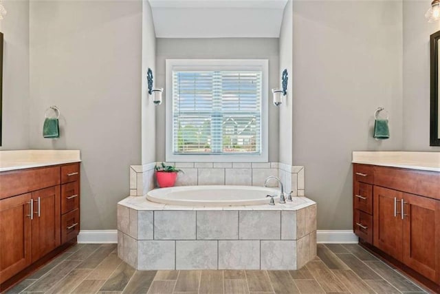 35 Huntington Way, Williamson, GA 30292 - full bath featuring baseboards, two vanities, wood finish floors, and a garden tub
