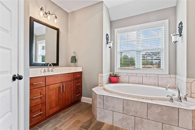 35 Huntington Way, Williamson, GA 30292 - bathroom featuring wood finished floors, a garden tub, vanity, and baseboards
