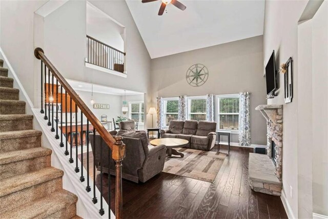 35 Huntington Way, Williamson, GA 30292 - living room featuring high vaulted ceiling, ceiling fan, stairs, a stone fireplace, and hardwood / wood-style flooring