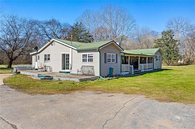 back of house with a yard and covered porch