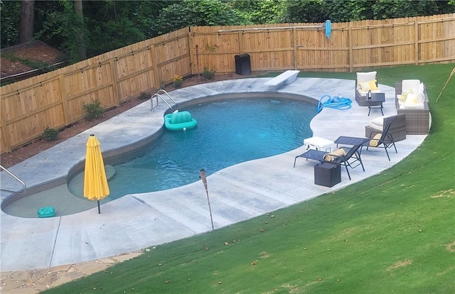 view of swimming pool featuring a fenced in pool, a lawn, a fenced backyard, and a patio area
