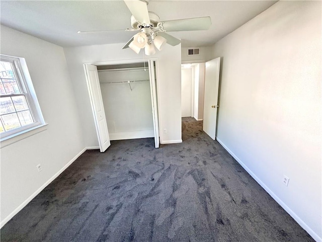 unfurnished bedroom with a closet, visible vents, baseboards, ceiling fan, and carpet floors