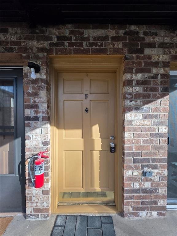 property entrance with brick siding