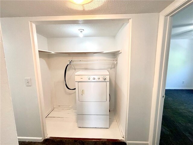 clothes washing area with washer / clothes dryer, baseboards, a textured ceiling, laundry area, and carpet