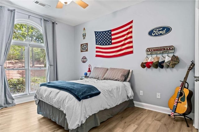 bedroom with ceiling fan and light wood-type flooring