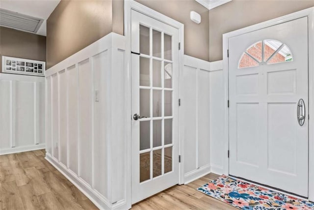 entrance foyer featuring light hardwood / wood-style floors and ornamental molding