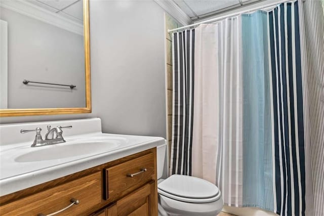 bathroom with vanity, toilet, walk in shower, and crown molding