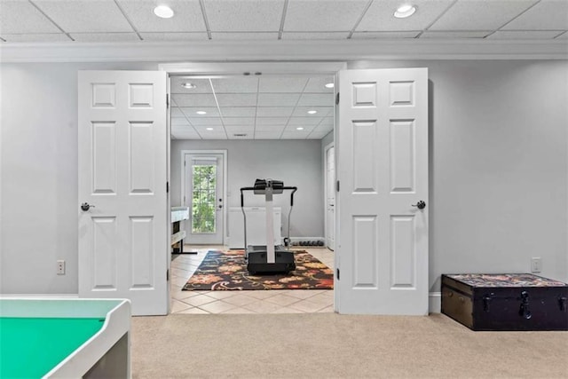 rec room featuring carpet floors and a drop ceiling