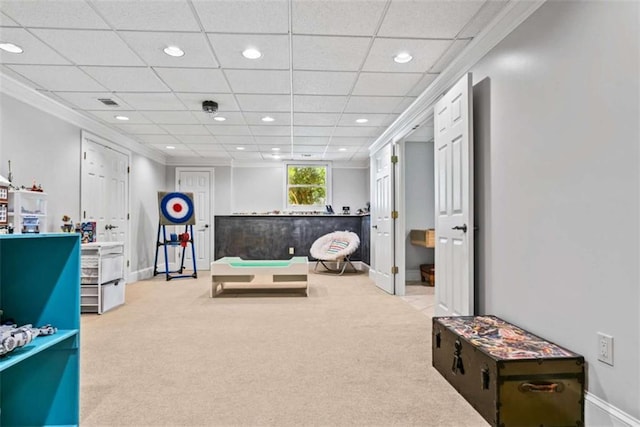 playroom featuring a paneled ceiling and light carpet