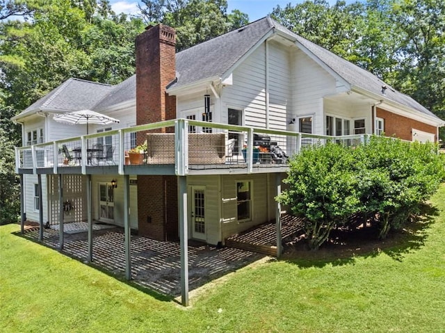 back of property with a lawn and a wooden deck