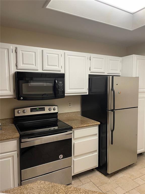 kitchen featuring appliances with stainless steel finishes and white cabinets