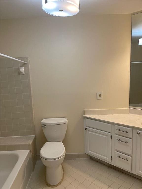 full bathroom with vanity, tiled shower / bath combo, tile patterned floors, and toilet