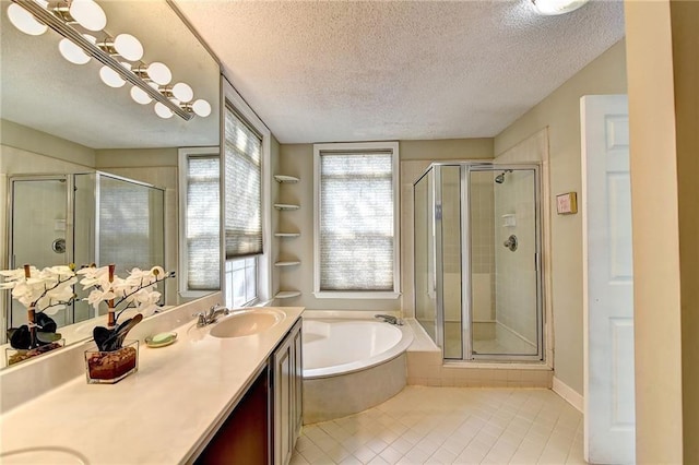 bathroom with tile patterned flooring, vanity, separate shower and tub, and a textured ceiling