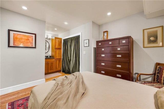 bedroom with recessed lighting, baseboards, and light wood-style floors