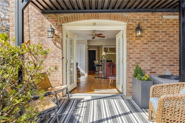 entrance to property featuring brick siding and french doors