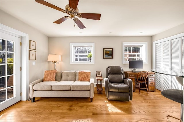 living room with ceiling fan and wood finished floors