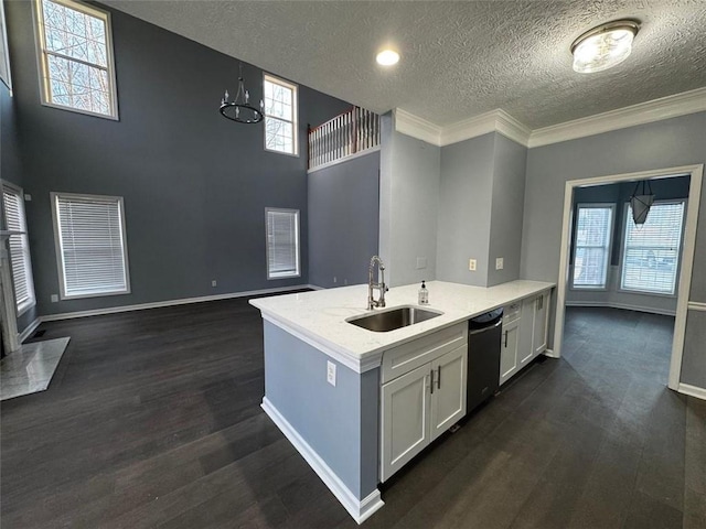 kitchen with sink, a textured ceiling, black dishwasher, white cabinetry, and a chandelier