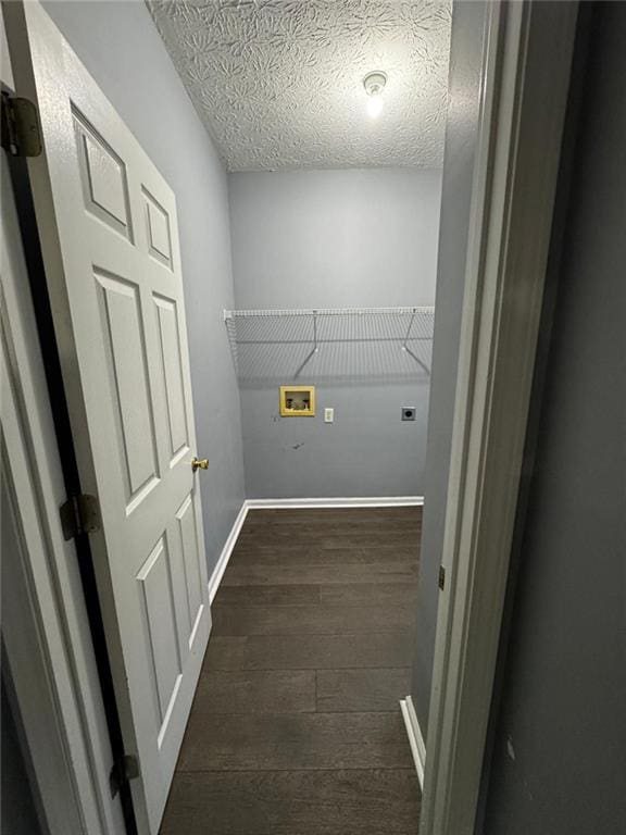 laundry area with hookup for an electric dryer, washer hookup, a textured ceiling, and dark wood-type flooring