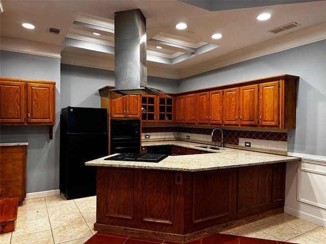 kitchen featuring kitchen peninsula, ornamental molding, island range hood, sink, and black appliances