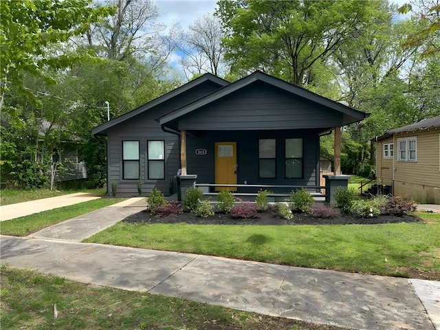 bungalow-style house featuring a porch and a front lawn