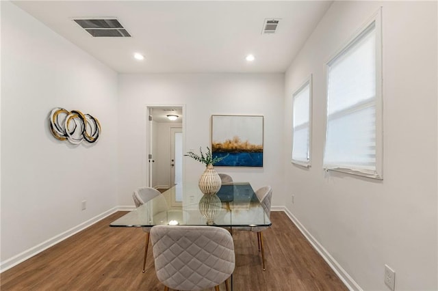 dining space featuring baseboards, visible vents, wood finished floors, and recessed lighting