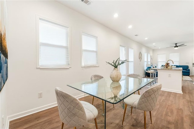 dining area featuring light wood finished floors, recessed lighting, visible vents, ceiling fan, and baseboards