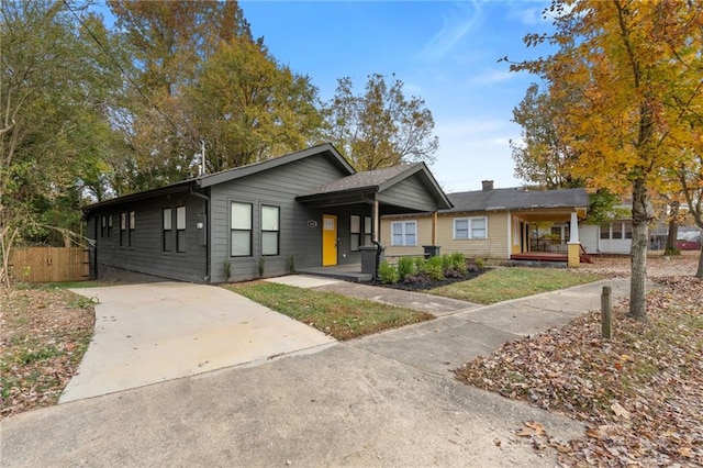 ranch-style home featuring fence